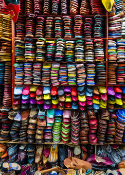 Stacks of colorful shoes arranged in an organized manner on wooden shelves Fez, Fez-Meknes, Northern Inland Morocco