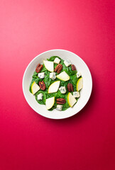 Salad with spinach, blue cheese, pear, and nuts. Healthy eating. Vegetarian food.