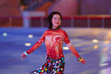 A person with short hair spins joyfully in colorful attire on a blurred urban background. Shanghai, China