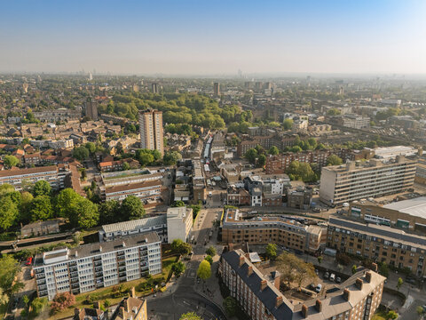 Aerial view of a sprawling urban landscape with residential buildings and greenery. London, UK