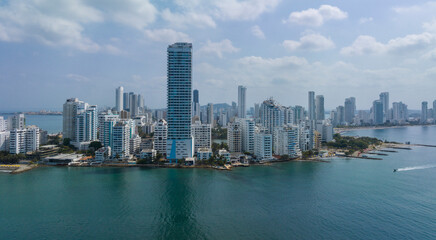 Skyline of a modern city with tall buildings near the water under a cloudy sky. Cartagena, Colombia