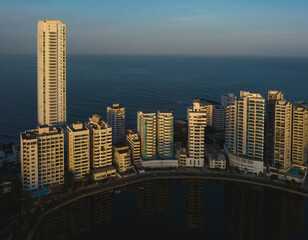 Coastal skyline at sunset with high-rise buildings and a calm ocean backdrop. Cartagena, Colombia