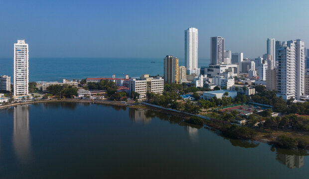 Aerial view of a coastal city skyline with skyscrapers and a reflective waterfront.   Cartagena, Colombia