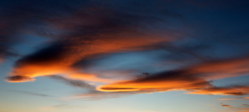 Vivid sunset sky with dramatic clouds illuminated in orange and red hues. Calgary, Canada
