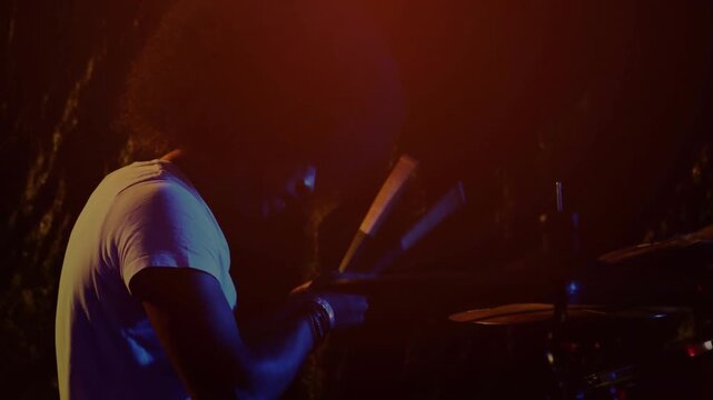 Male drummer starting alternating stick hits after circular HUD appearing over center for music