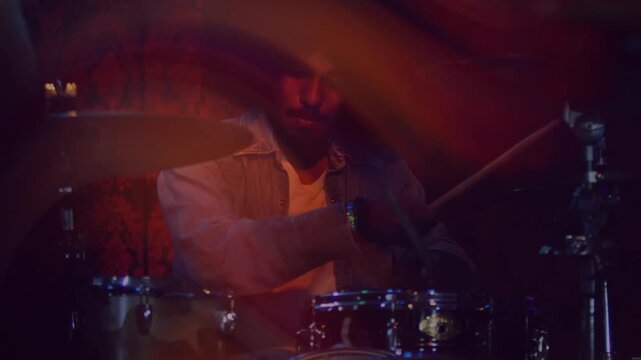 Light streaks revealing male drummer playing drum kit for music, animated trails accenting strikes