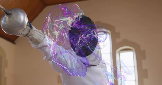 Male fencer holding epee and extending arm, forming purple plume wrapping blade mask in sports hall