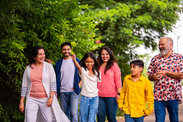 Indian family enjoying outdoor walk and laughter while bonding together on road
