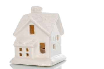 Toy clay decorative New Year's huts isolated on white background, close-up.