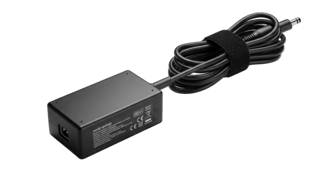 Black power adapter with coiled cable, isolated on transparent background