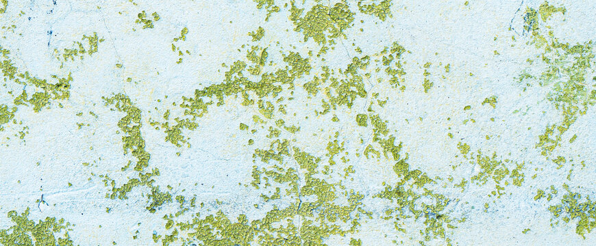 Peeling painted concrete wall, cracks of green blue and beige, peeling paint of the old rough concrete wall, peeling paint texture