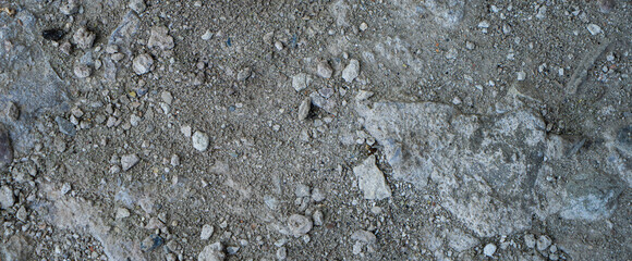 Close-up of a gray-black lava texture on the ground. Porous, cracked, and stony, perfect as a stock texture or photo background. Impression of molten rock.