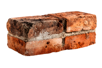 Close up of a weathered and aged red brick with visible texture and imperfections