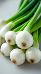 Fresh green onions bundle on white surface