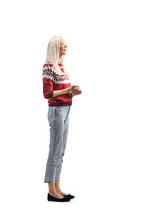 Full length profile shot of a woman in a christmas sweater