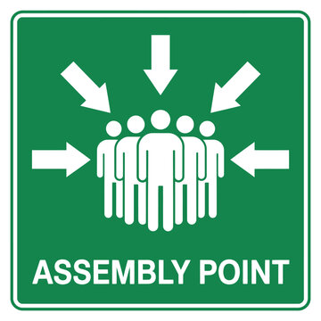 Green assembly point sign with white arrows and figures