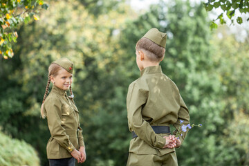 Two children in military uniforms from the Second World War