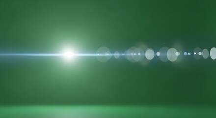 Bright light with lens flare effect on a green background creating a bokeh effect and a light streak