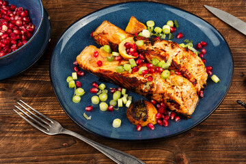 Appetizing fried fish steak on wooden surface.