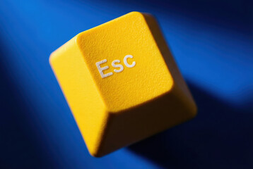 Bright Yellow ESC Key Against Deep Blue Background Symbolizing Escape and Freedom