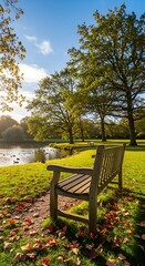 A scenic park landscape featuring a wooden bench in the foreground, overlooking a serene pond and lush trees bathed in sunlight