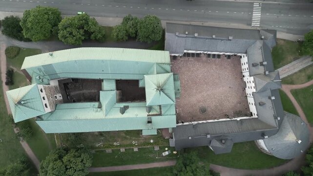 Descending drone video showcases a aerial top view of the Castle of Turku, Finland