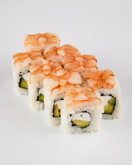 Gourmet shrimp and avocado uramaki layered on rice on white