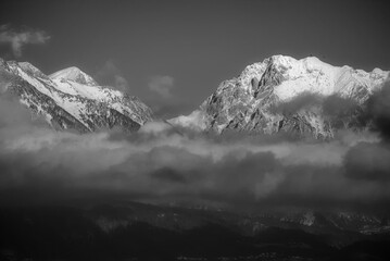 BW landscape of the Kamnik–Savinja Alps viewed from Ljubljana, featuring the peaks of Brana,...