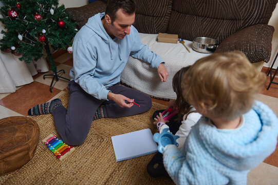 Father And Kids At Home: Christmas Tree, Coloring, And Simple Chat During A Cozy Weekday - Powered by Adobe