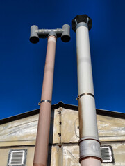 Two exhaust or ventilation pipes in garage for a automobile