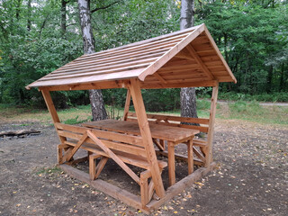 Wooden gazebo for relaxing in a forest