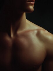 Close-up portrait of a woman's upper body. the focus is on her neck and upper chest area, which is covered in a golden-brown light.