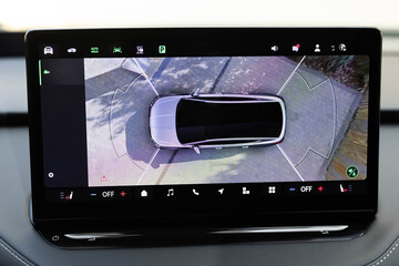 Surround view monitor. Dashboard display screen with multimedia and 360 camera view in a new luxury vehicle. Front camera of circular 360 degrees view system. 360 terrain system in a modern car.