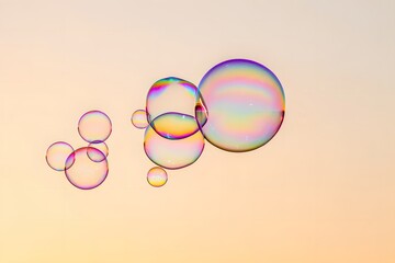 Iridescent soap bubbles floating against a softly lit background