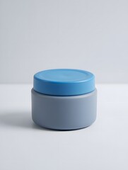 Minimalist blue and gray cosmetic jar on white background