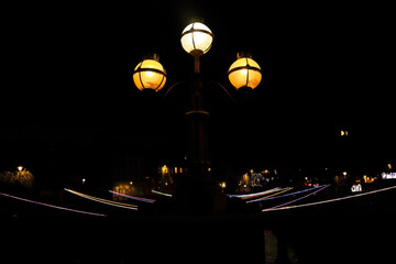 Old fashioned street lights over the river cart at Christmas