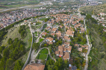 Aerial view of Berat Castle showing its stone fortifications, traditional hilltop homes and the city spreading across the valley.