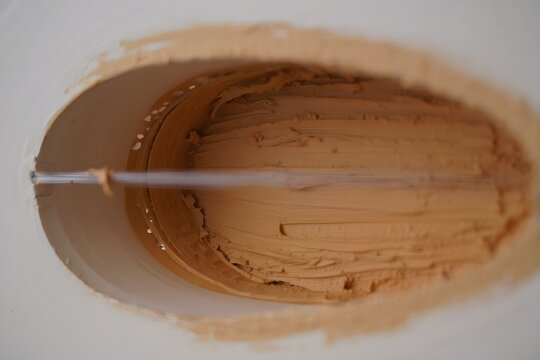 Artist applying textured paint to a canvas with a palette knife - Powered by Adobe