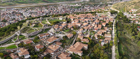 Aerial view of Berat Castle showing its fortified walls, traditional homes and the city spreading across the Osum River valley.