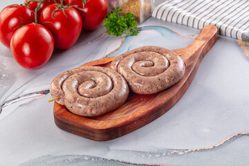 Raw meat pork and beef swirl sausages