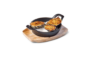 Gratin oysters preparing as seafood appetizer in black cast iron skillet