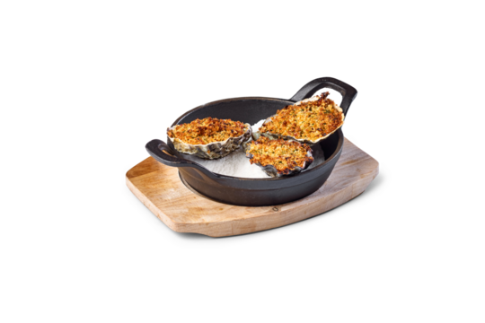Gratin oysters preparing as seafood appetizer in black cast iron skillet