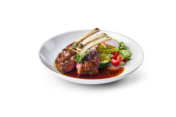 Rack of lamb and fresh salad dish with sauce isolated on white background