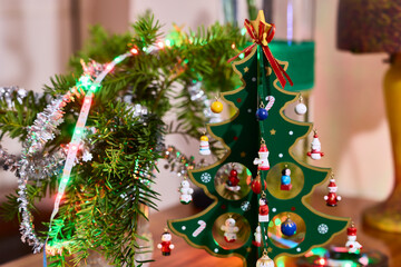 Christmas decorations. Tinsel, small wooden tree, and figurines for Christmas decorations.