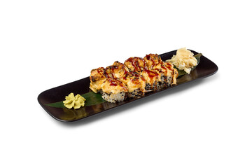 Baked tempura sushi rolls with ginger and wasabi on a black plate, ready to eat