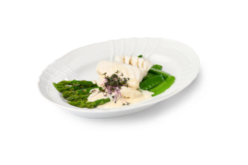 White fish fillet, asparagus, and snow peas served with a creamy sauce on a white plate