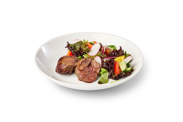 Grilled beef tenderloin served with refreshing garden salad on a white plate