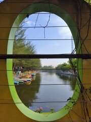 Naklejka premium View of the tourist lake from an oval window.