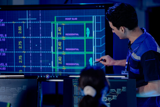 architect presents a digital blueprint for a future smart home. Using a tablet and AI, he plans a sustainable ESG real estate development and digital construction.