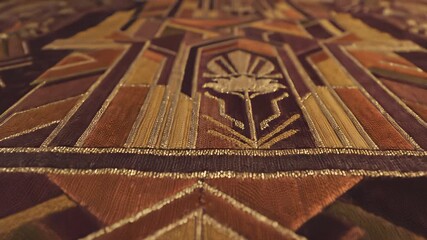 Luxurious vintage inspired decorative rug with intricate geometric patterns, featuring luxurious gold and brown tones, perfect for conveying refined taste and appreciation for fine details.